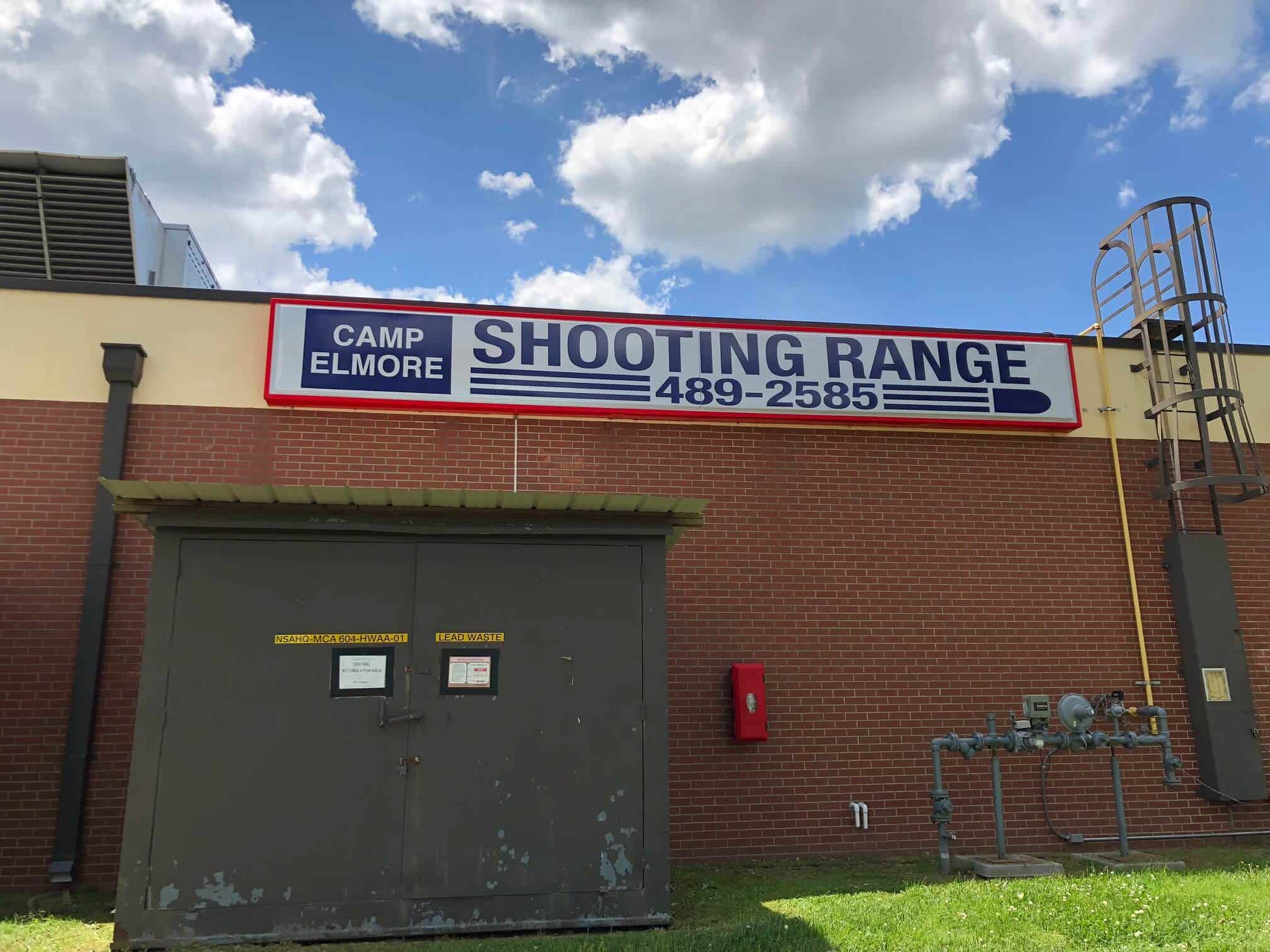 Shooting Range sign mounted on building for Camp Elmore