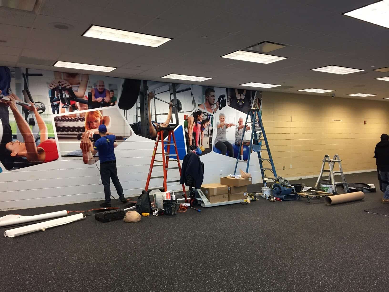 Gym wall mural installation by DeSigns Inc.