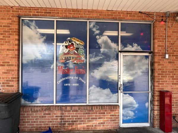 Perforated window film graphics allows in light and offers privacy and security.