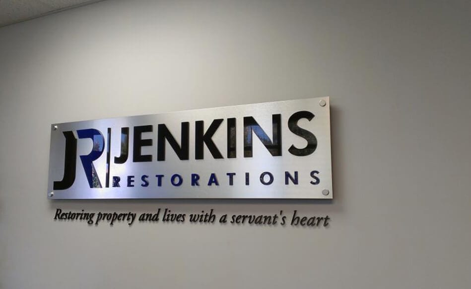 Brush metal style mounted lobby sign by DeSigns, Inc.